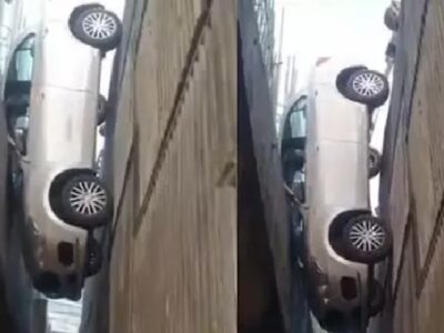 car hangs from flyover